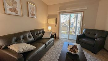 a living room with leather couches and a coffee table